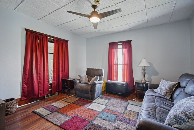417 NE 2nd St, Panora, IA 50216 - living room featuring a drop ceiling, ceiling fan, and wood finished floors