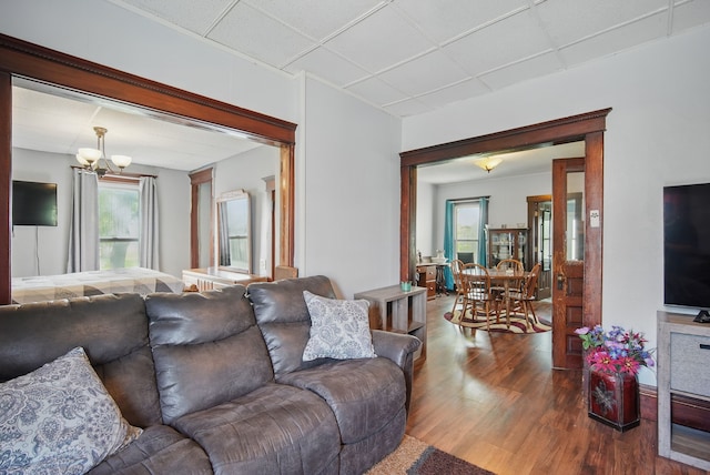 417 NE 2nd St, Panora, IA 50216 - living area with wood finished floors, a chandelier, and plenty of natural light