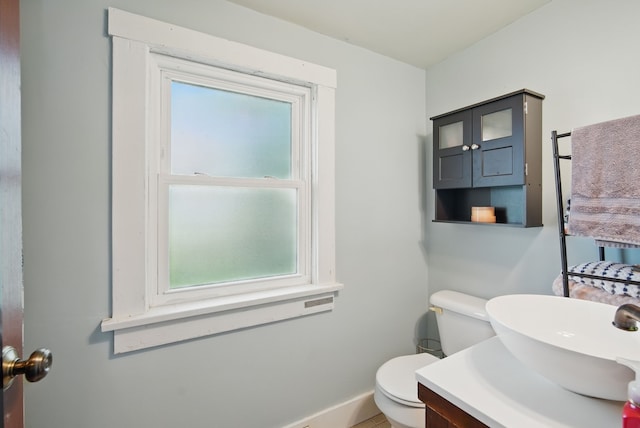 417 NE 2nd St, Panora, IA 50216 - half bathroom with toilet, healthy amount of natural light, vanity, and baseboards