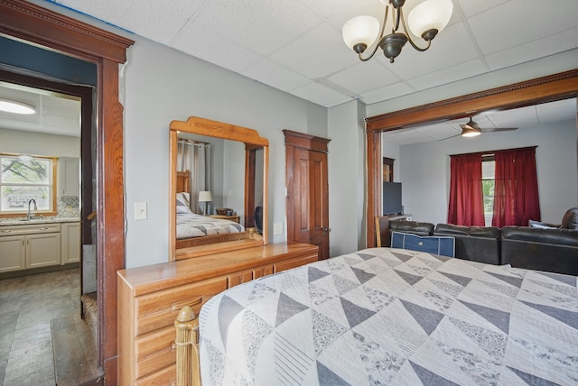 417 NE 2nd St, Panora, IA 50216 - bedroom featuring a chandelier, a sink, and a paneled ceiling