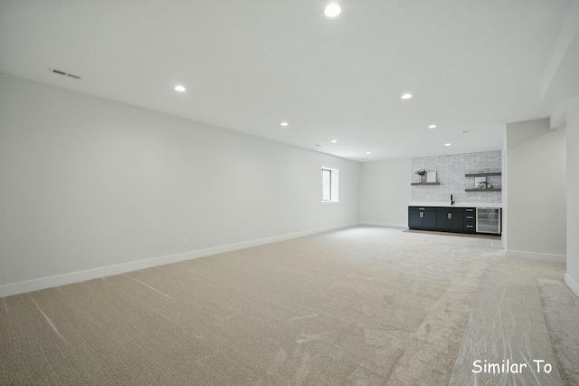 1801 Summit Cir NE, Bondurant, IA 50035 - unfurnished living room featuring recessed lighting, light carpet, baseboards, and a sink