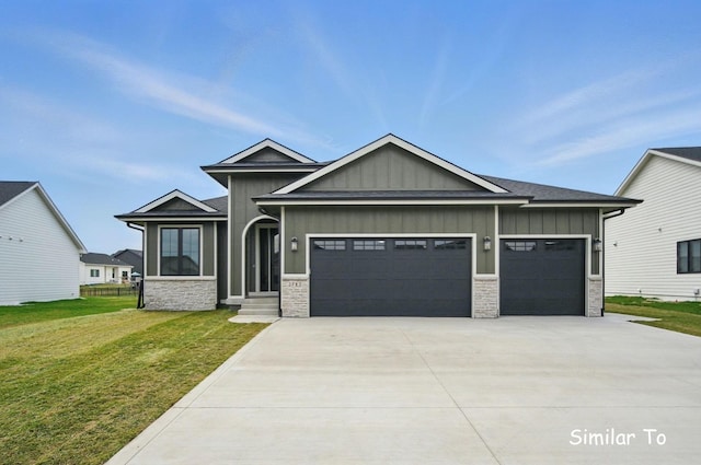1801 Summit Cir NE, Bondurant, IA 50035 - view of front facade with board and batten siding, a garage, stone siding, concrete driveway, and a front lawn