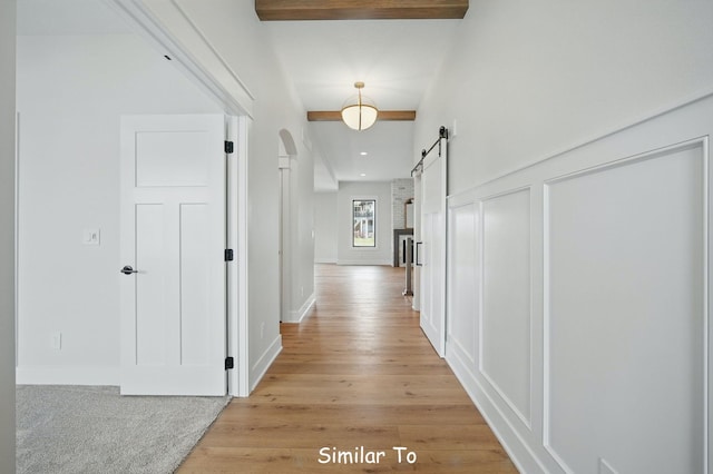 1801 Summit Cir NE, Bondurant, IA 50035 - hallway featuring a barn door, light wood finished floors, arched walkways, and recessed lighting
