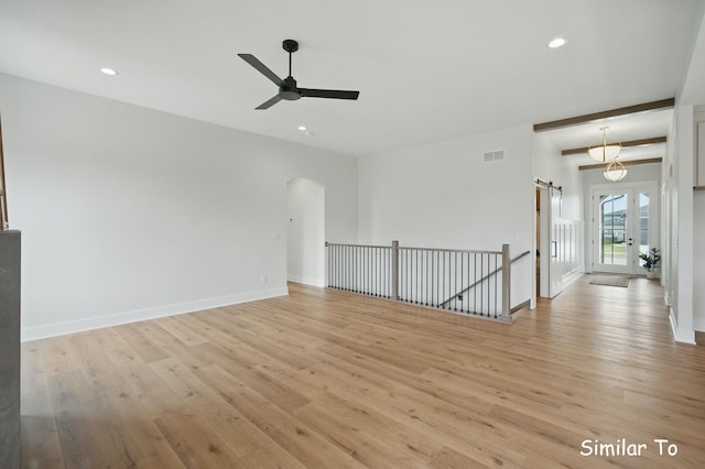 1801 Summit Cir NE, Bondurant, IA 50035 - empty room with ceiling fan, light wood-style floors, recessed lighting, arched walkways, and baseboards