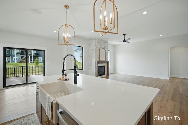1801 Summit Cir NE, Bondurant, IA 50035 - kitchen with a sink, a chandelier, light wood-type flooring, ceiling fan, and recessed lighting
