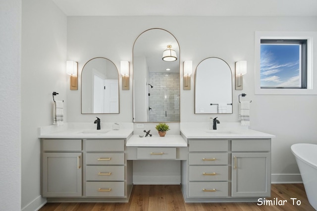 1801 Summit Cir NE, Bondurant, IA 50035 - bathroom with a stall shower, two vanities, a soaking tub, and wood finished floors