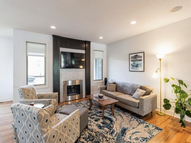 4485 NW 167th St, Clive, IA 50325 - living room featuring light wood-style floors, baseboards, a fireplace, and recessed lighting