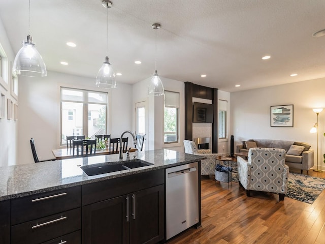 4485 NW 167th St, Clive, IA 50325 - kitchen with stainless steel dishwasher, a sink, open floor plan, dark wood-type flooring, and recessed lighting