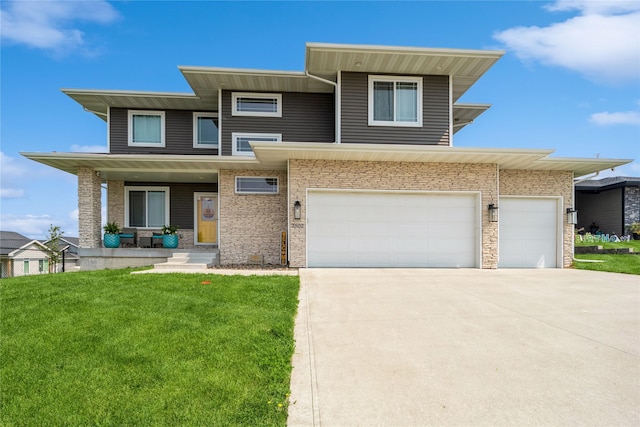 2502 Eagle Ridge Dr, Granger, IA 50109 - prairie-style home featuring driveway, a front lawn, covered porch, and an attached garage