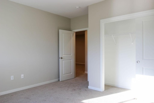 5515 167th St, Urbandale, IA 50323 - unfurnished bedroom featuring light carpet, a closet, and baseboards
