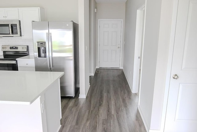 5515 167th St, Urbandale, IA 50323 - kitchen with stainless steel appliances, dark wood-style floors, baseboards, and white cabinetry