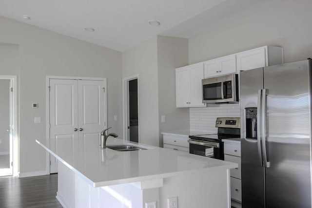 5515 167th St, Urbandale, IA 50323 - kitchen featuring appliances with stainless steel finishes, a sink, an island with sink, decorative backsplash, and light countertops