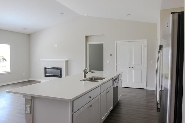 5515 167th St, Urbandale, IA 50323 - kitchen featuring appliances with stainless steel finishes, a sink, dark wood-type flooring, light countertops, and vaulted ceiling
