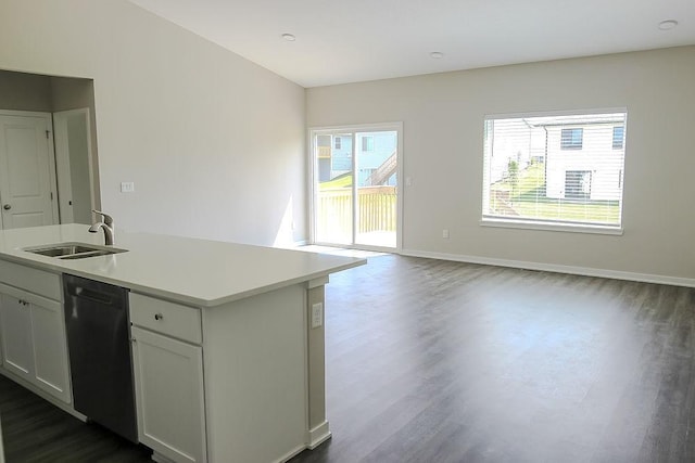 5515 167th St, Urbandale, IA 50323 - kitchen with stainless steel dishwasher, a sink, dark wood-style flooring, and light countertops