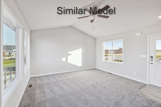 429 Napoli Ave, West Des Moines, IA 50266 - empty room featuring a ceiling fan, plenty of natural light, carpet flooring, and vaulted ceiling