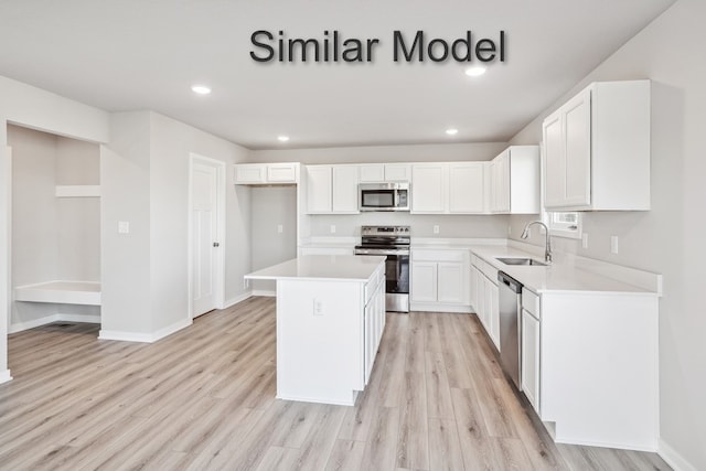 429 Napoli Ave, West Des Moines, IA 50266 - kitchen with appliances with stainless steel finishes, a sink, light wood-style flooring, white cabinetry, and recessed lighting