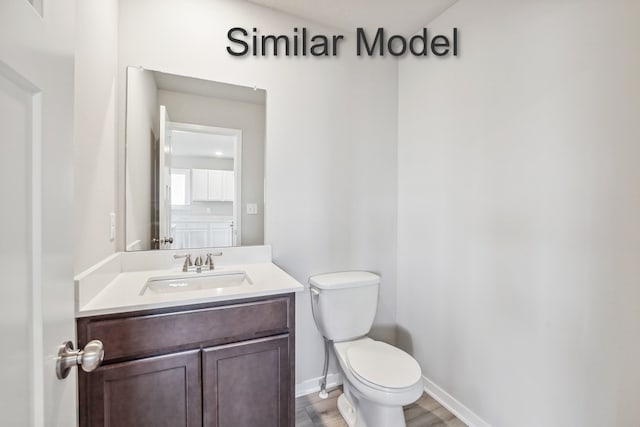 429 Napoli Ave, West Des Moines, IA 50266 - half bath featuring toilet, vanity, wood finished floors, and baseboards