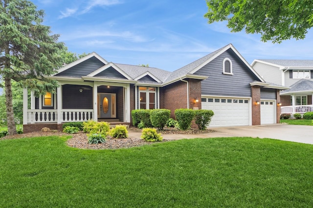 8148 Durham Cir, Johnston, IA 50131 - view of front of home with a porch, an attached garage, driveway, and a front lawn