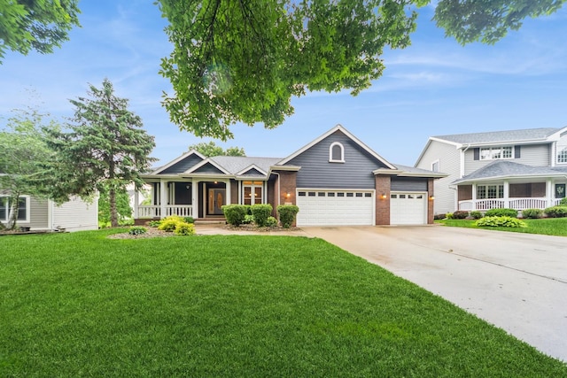 8148 Durham Cir, Johnston, IA 50131 - view of front of house with covered porch, a garage, driveway, a front yard, and brick siding