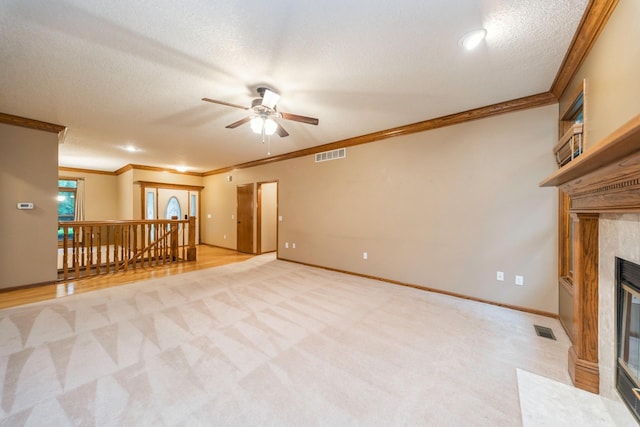 8148 Durham Cir, Johnston, IA 50131 - unfurnished living room with crown molding, a ceiling fan, light carpet, a textured ceiling, and a fireplace