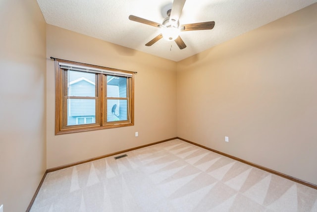 8148 Durham Cir, Johnston, IA 50131 - unfurnished room featuring ceiling fan, light colored carpet, baseboards, and a textured ceiling
