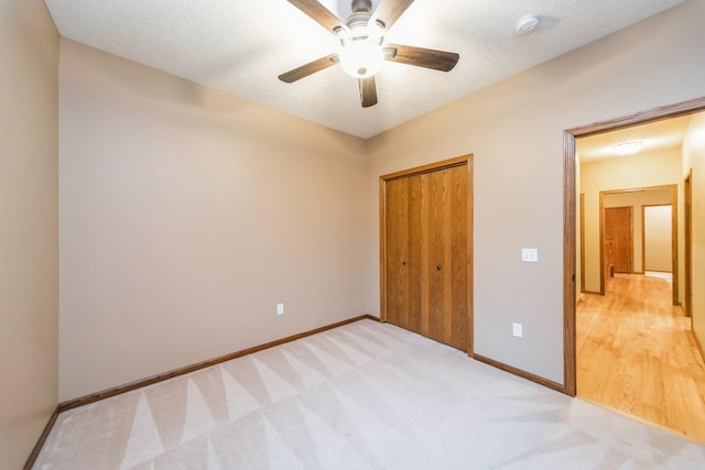 8148 Durham Cir, Johnston, IA 50131 - unfurnished bedroom featuring baseboards, a closet, light colored carpet, and a ceiling fan