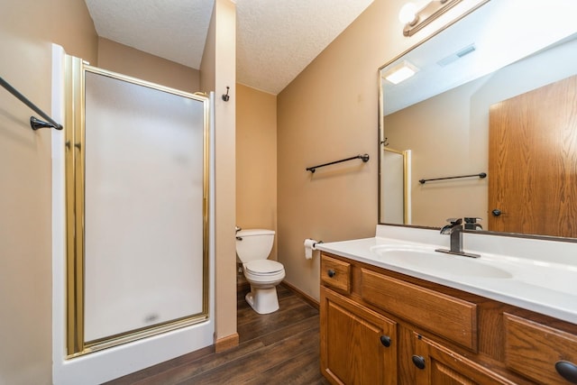 8148 Durham Cir, Johnston, IA 50131 - full bath with toilet, wood finished floors, vanity, a shower stall, and a textured ceiling