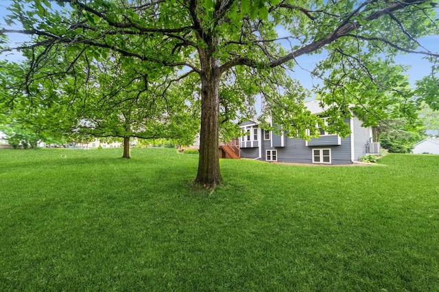 8148 Durham Cir, Johnston, IA 50131 - view of grassy yard featuring central air condition unit