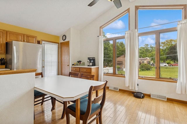 1801 Payton Ave, Des Moines, IA 50315 - dining room with baseboards, light wood-type flooring, a ceiling fan, and high vaulted ceiling