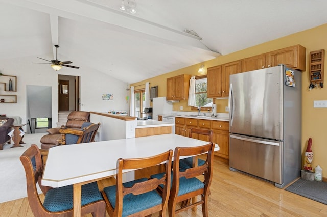1801 Payton Ave, Des Moines, IA 50315 - kitchen featuring freestanding refrigerator, light countertops, light wood-type flooring, a sink, and a ceiling fan