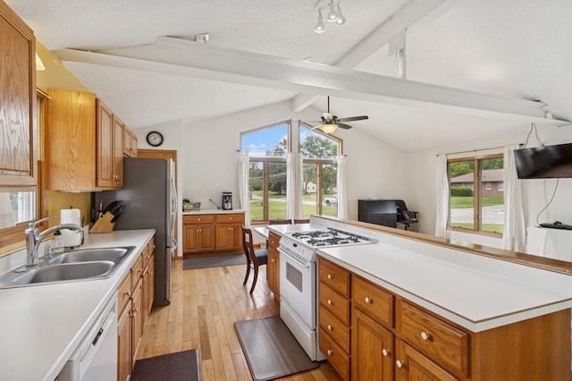 1801 Payton Ave, Des Moines, IA 50315 - kitchen featuring white appliances, a sink, light wood-style flooring, ceiling fan, and light countertops