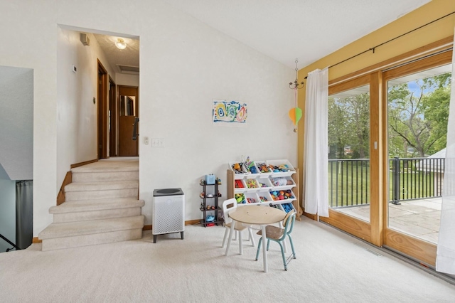1801 Payton Ave, Des Moines, IA 50315 - recreation room with vaulted ceiling, baseboards, and carpet flooring