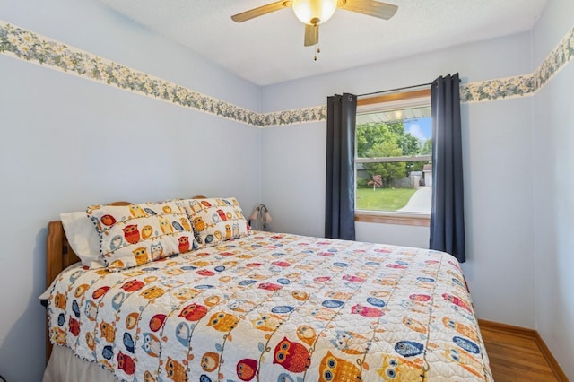 1801 Payton Ave, Des Moines, IA 50315 - bedroom featuring wood finished floors, ceiling fan, and baseboards