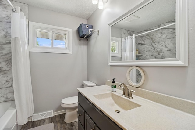 1801 Payton Ave, Des Moines, IA 50315 - bathroom with vanity, toilet, wood finished floors, shower / tub combo with curtain, and a textured ceiling