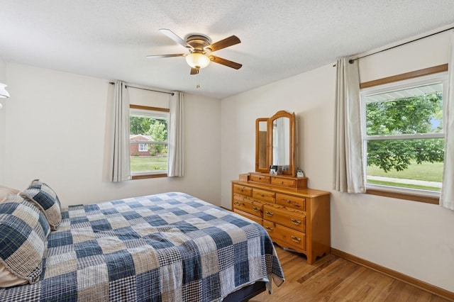 1801 Payton Ave, Des Moines, IA 50315 - bedroom featuring light wood-type flooring, baseboards, and a ceiling fan