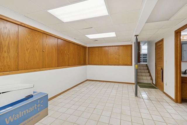 1801 Payton Ave, Des Moines, IA 50315 - empty room with stairs, a paneled ceiling, and baseboards