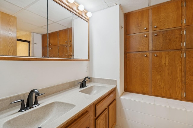 1801 Payton Ave, Des Moines, IA 50315 - full bathroom featuring double vanity and a drop ceiling