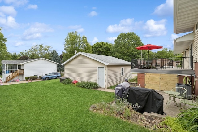 1801 Payton Ave, Des Moines, IA 50315 - view of green lawn with an outbuilding and central AC