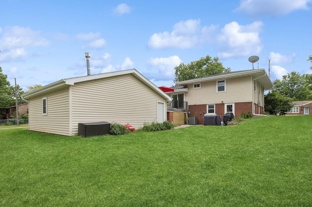 1801 Payton Ave, Des Moines, IA 50315 - rear view of property featuring a yard and central AC unit