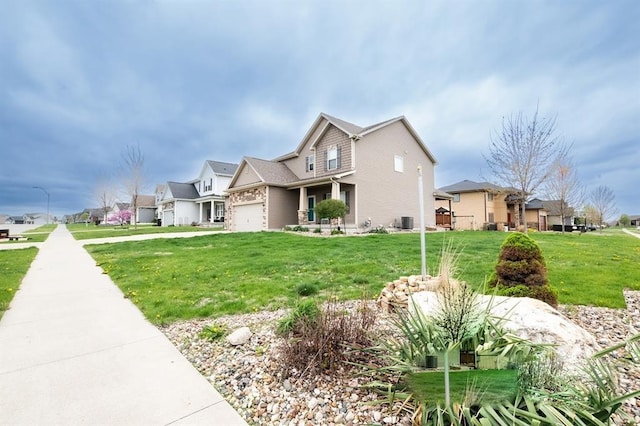 2430 SE Willowbrook Dr, Waukee, IA 50263 - view of front of property featuring a front lawn, a garage, a residential view, and cooling unit