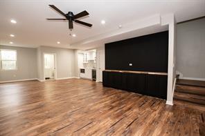 2430 SE Willowbrook Dr, Waukee, IA 50263 - unfurnished living room with wood finished floors, baseboards, recessed lighting, and stairway