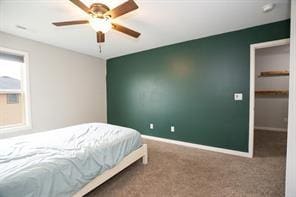 2430 SE Willowbrook Dr, Waukee, IA 50263 - bedroom with carpet, baseboards, a walk in closet, and ceiling fan