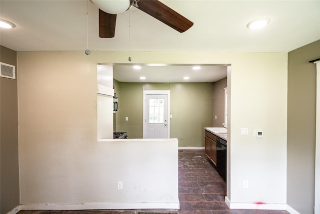 3518 Easton Blvd, Des Moines, IA 50317 - kitchen featuring dishwasher, baseboards, dark wood finished floors, a ceiling fan, and light countertops