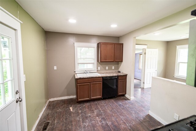 3518 Easton Blvd, Des Moines, IA 50317 - kitchen featuring black dishwasher, brown cabinetry, a sink, dark wood-style flooring, and recessed lighting