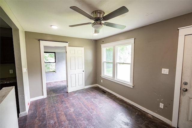 3518 Easton Blvd, Des Moines, IA 50317 - spare room with healthy amount of natural light, dark wood-style floors, baseboards, and ceiling fan