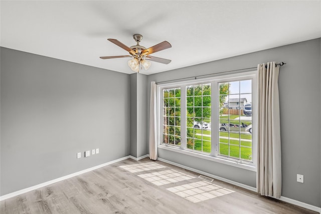 904 SE Little Beaver Dr, Grimes, IA 50111 - unfurnished room with baseboards, wood finished floors, and ceiling fan
