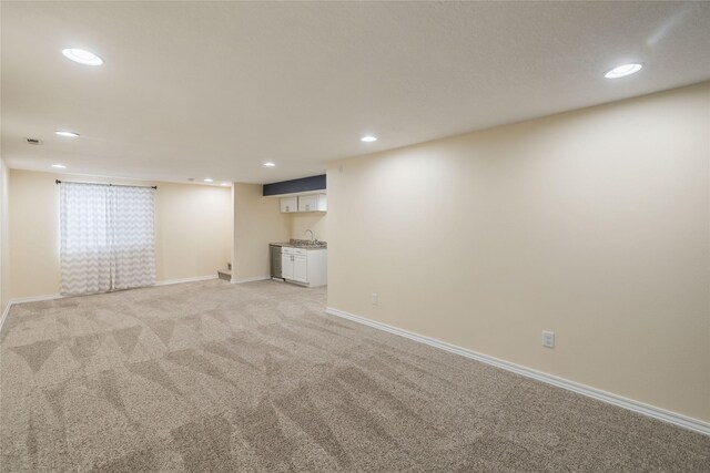 904 SE Little Beaver Dr, Grimes, IA 50111 - finished below grade area with recessed lighting, light colored carpet, baseboards, and a sink
