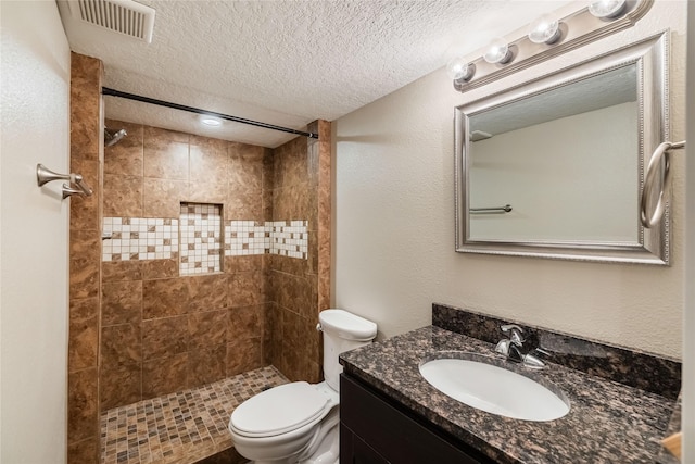 904 SE Little Beaver Dr, Grimes, IA 50111 - full bath featuring a textured ceiling, toilet, vanity, and tiled shower