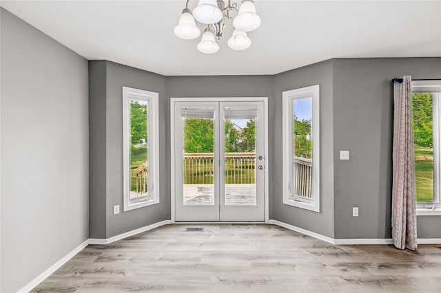 904 SE Little Beaver Dr, Grimes, IA 50111 - entryway featuring a chandelier, wood finished floors, and baseboards