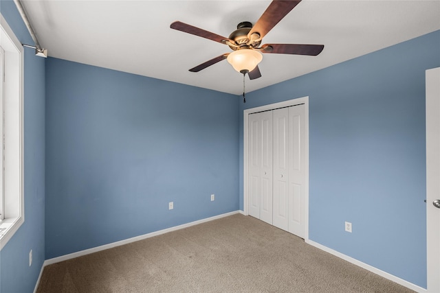904 SE Little Beaver Dr, Grimes, IA 50111 - unfurnished bedroom featuring carpet flooring, a closet, baseboards, and ceiling fan